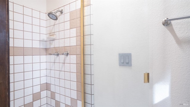 full bath with a tile shower