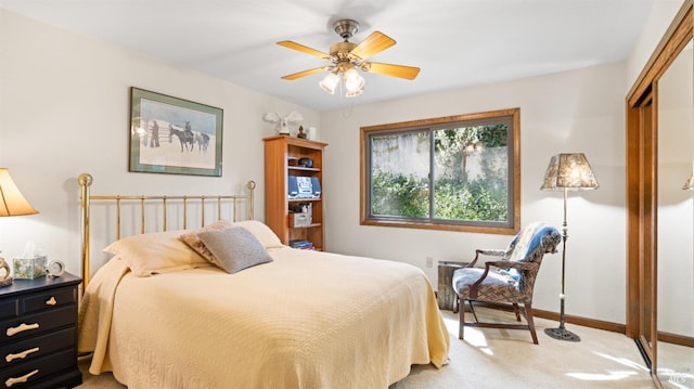 bedroom featuring a closet, light colored carpet, and baseboards