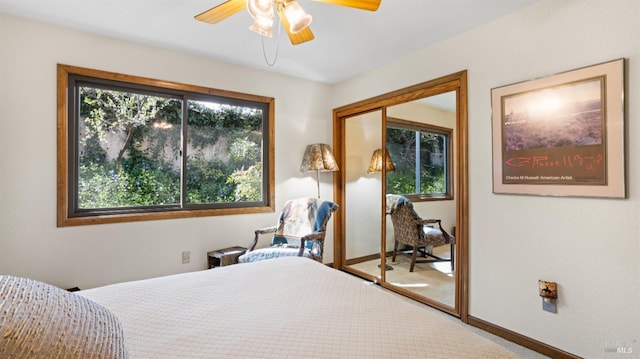 bedroom with baseboards, multiple windows, carpet floors, and ceiling fan