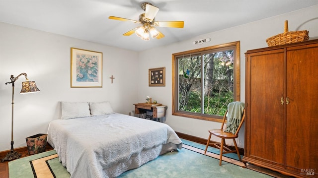 bedroom featuring baseboards and ceiling fan