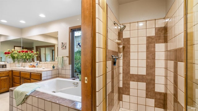 bathroom with a stall shower, vanity, and a bath