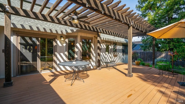 wooden deck featuring a pergola and fence