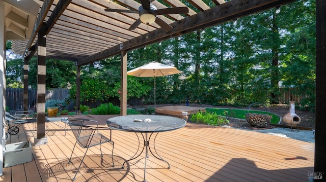 wooden terrace featuring a pergola, outdoor dining area, and fence