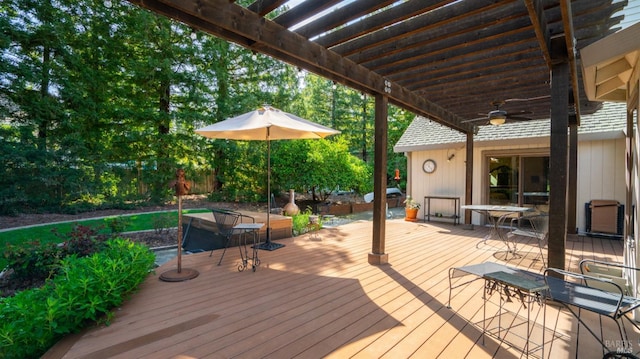 deck featuring a ceiling fan and a pergola