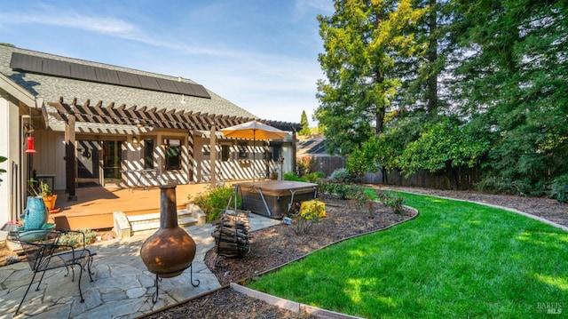 view of yard featuring a fire pit, fence, a deck, a patio area, and a pergola