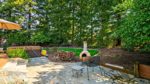 view of patio with a fenced backyard and a hot tub