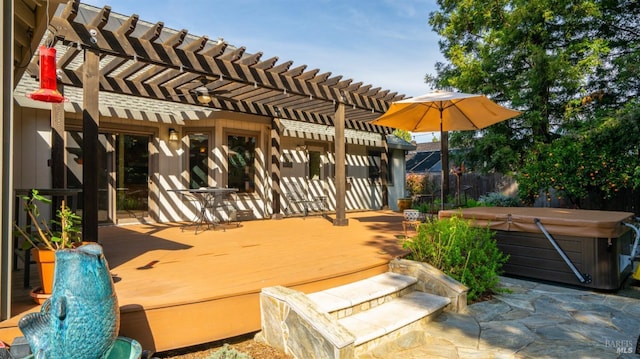 view of patio / terrace featuring fence, a deck, a pergola, and a hot tub