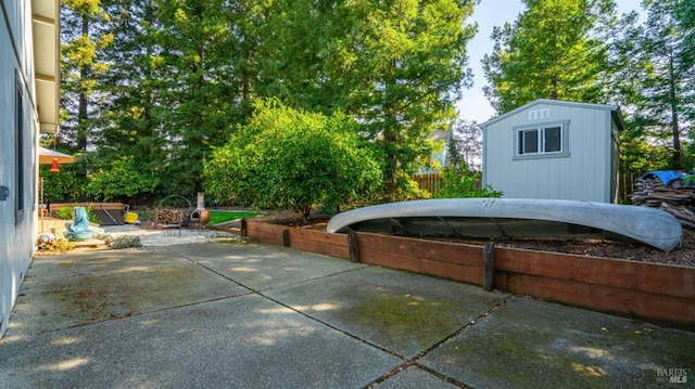 view of patio featuring fence, an outbuilding, and a shed