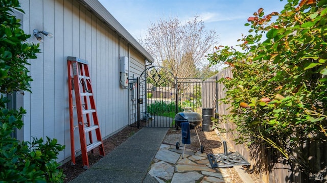 view of side of home with a gate and fence