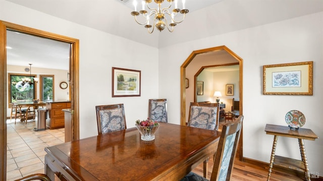 dining room with a notable chandelier and arched walkways