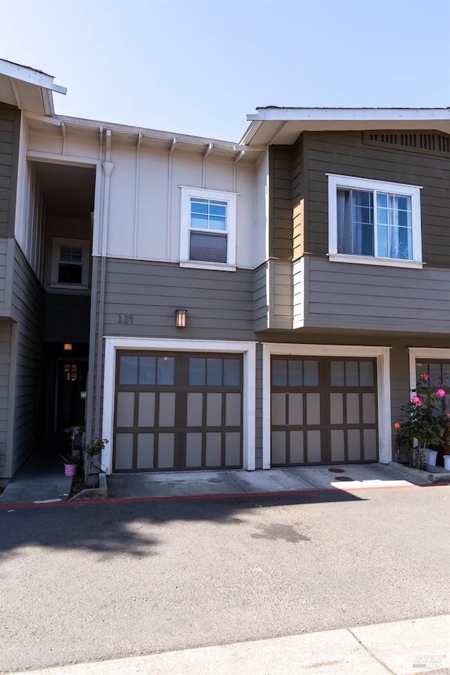 view of side of home featuring an attached garage