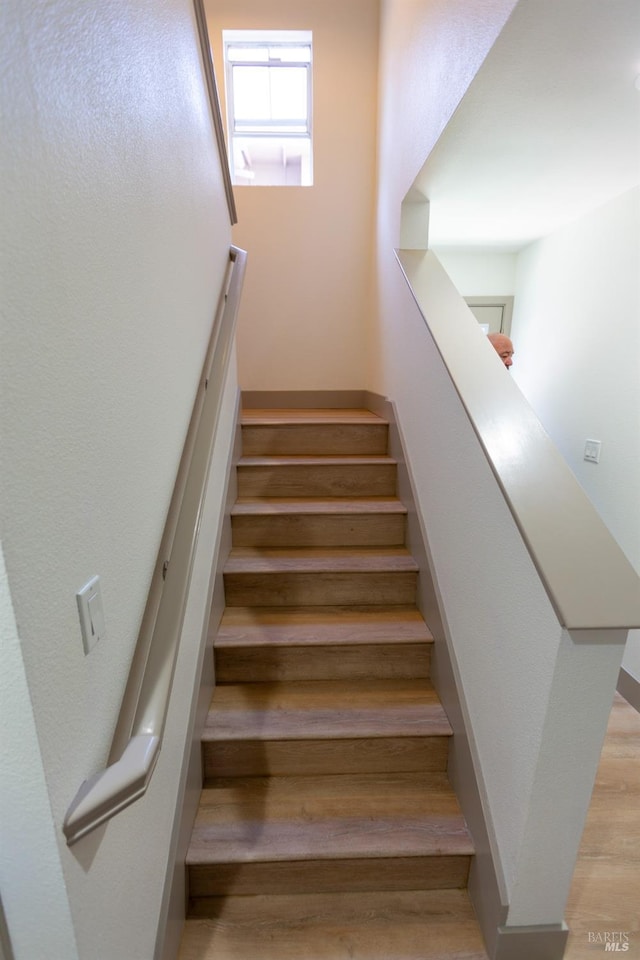 stairway featuring wood finished floors