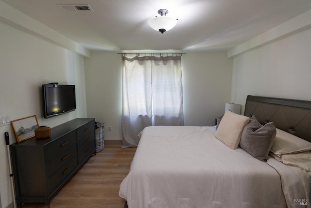 bedroom featuring visible vents and light wood-style flooring