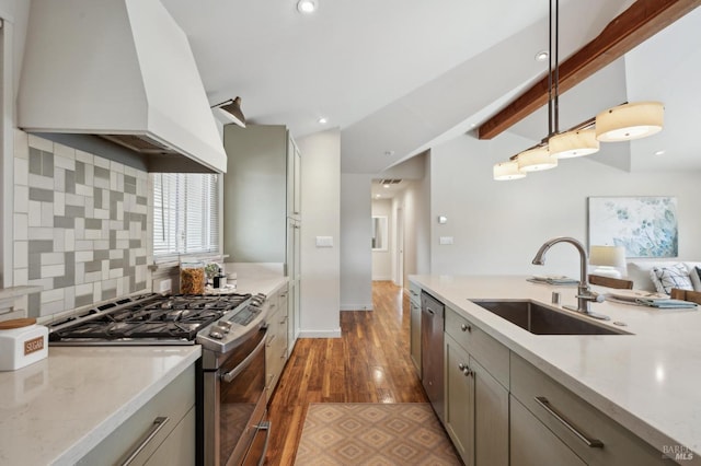 kitchen featuring gray cabinets, a sink, stainless steel appliances, custom range hood, and tasteful backsplash