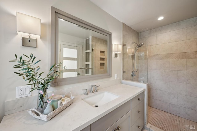 bathroom with vanity, recessed lighting, and walk in shower