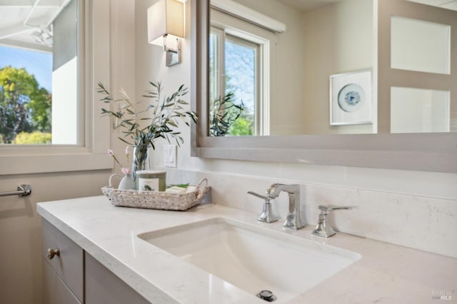 bathroom with plenty of natural light and vanity