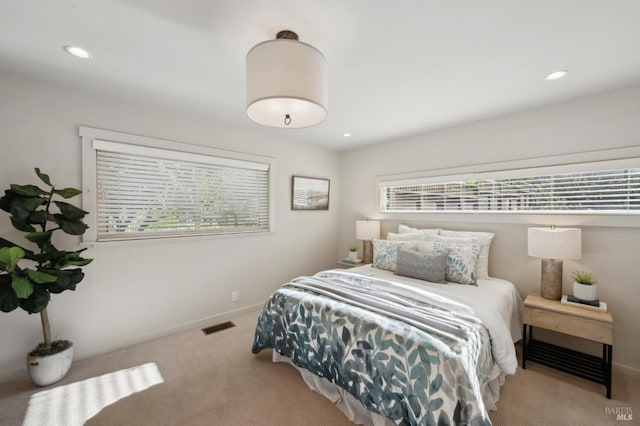 bedroom featuring recessed lighting, multiple windows, baseboards, and carpet floors