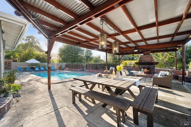 view of swimming pool with a fenced in pool, a patio, a fenced backyard, and an outdoor living space with a fireplace