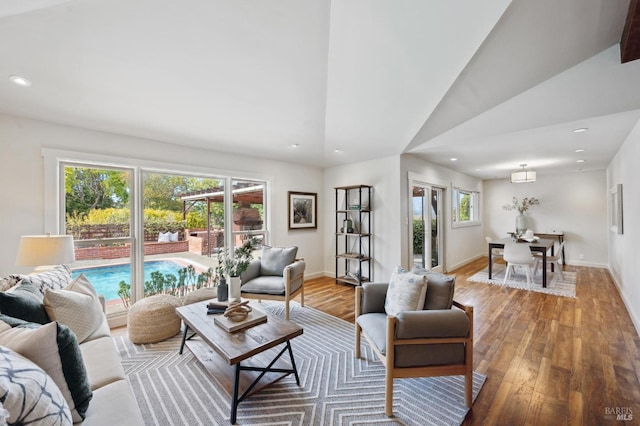 living room with recessed lighting, baseboards, and hardwood / wood-style flooring