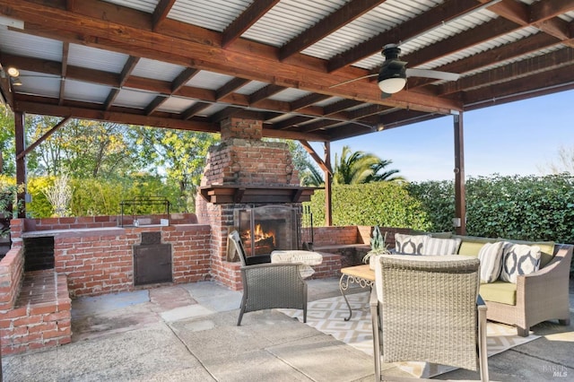 view of patio / terrace with ceiling fan and an outdoor brick fireplace