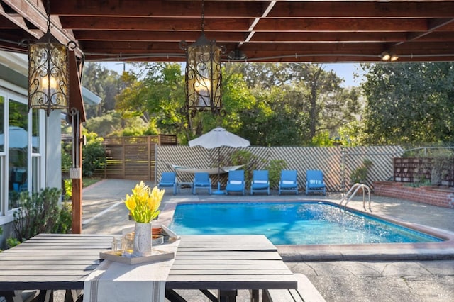 view of swimming pool with outdoor dining space, fence, a patio area, and a fenced in pool