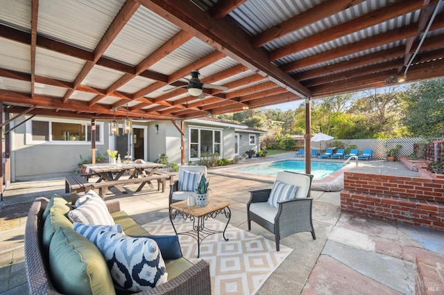 view of patio / terrace featuring fence, a fenced in pool, outdoor dining area, ceiling fan, and an outdoor hangout area