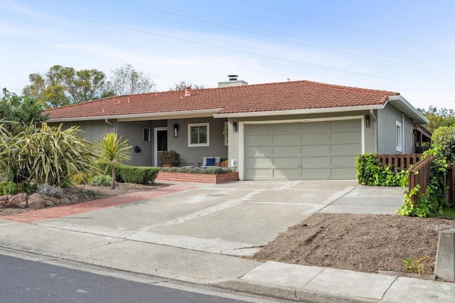 single story home featuring a tiled roof, concrete driveway, stucco siding, a chimney, and an attached garage