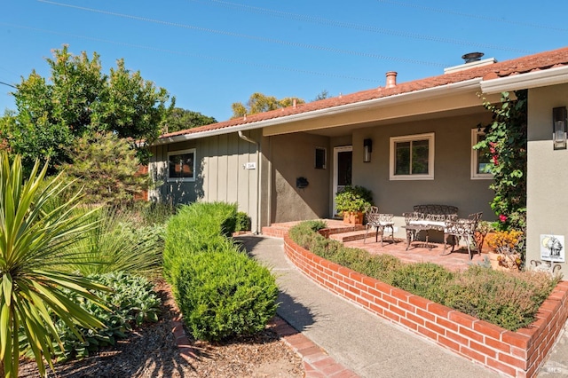 property entrance featuring stucco siding and a patio area