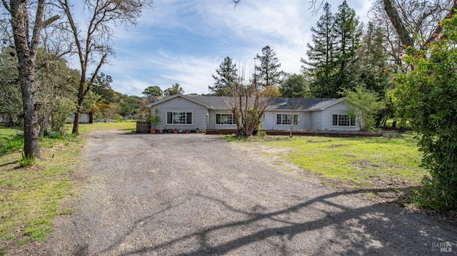 ranch-style house with a front lawn and driveway