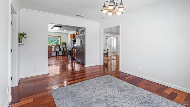 interior space with dark wood finished floors, a notable chandelier, crown molding, and visible vents