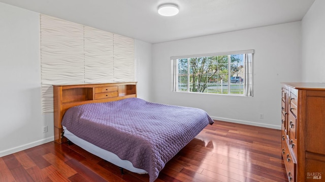 bedroom featuring baseboards and hardwood / wood-style floors