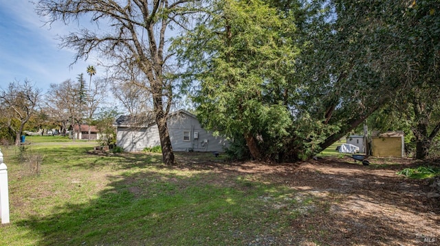 view of yard with a storage shed and an outdoor structure