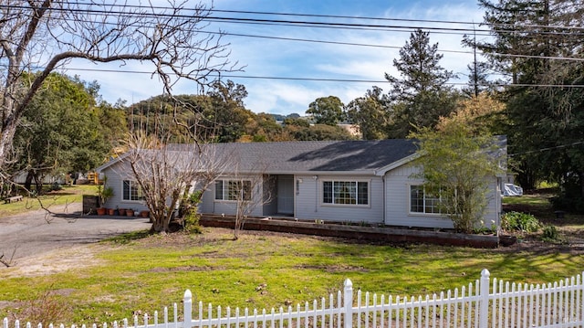 single story home featuring a fenced front yard, driveway, and a front lawn