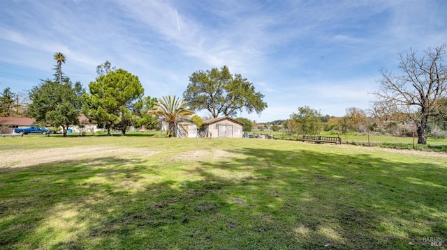 view of yard featuring an outbuilding and a rural view