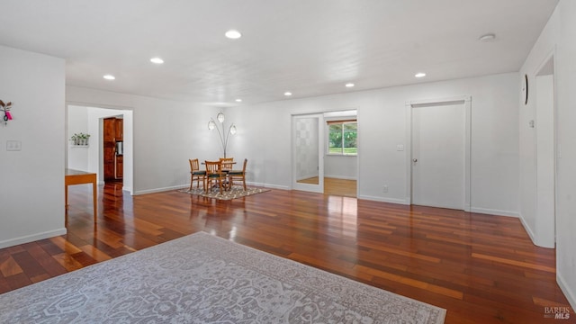 empty room featuring recessed lighting, baseboards, and hardwood / wood-style floors