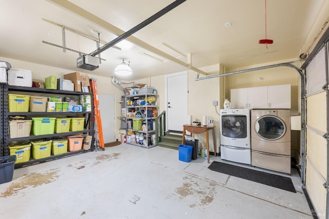 garage featuring washer and dryer and a garage door opener