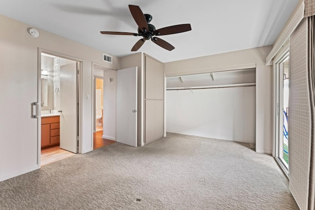 unfurnished bedroom with visible vents, light colored carpet, a closet, and ceiling fan