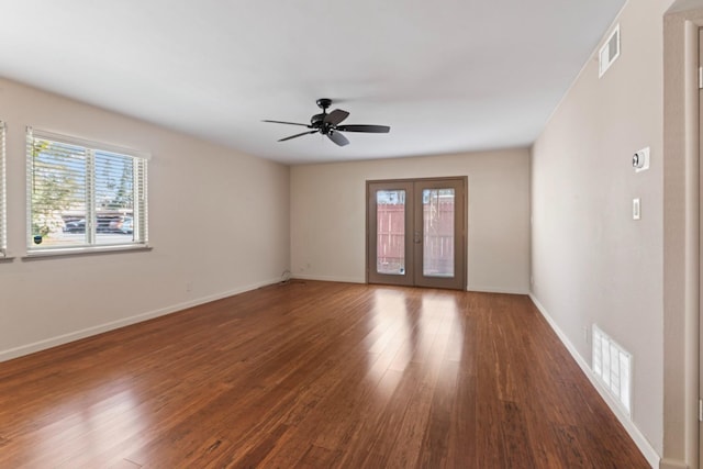 unfurnished room featuring wood finished floors, french doors, visible vents, and a healthy amount of sunlight