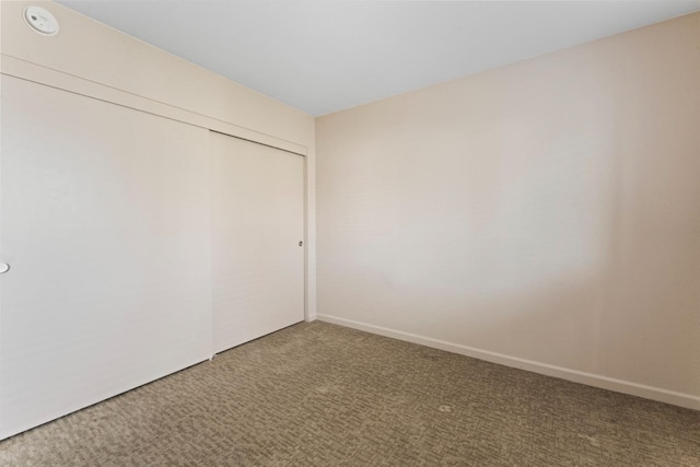 spare room with carpet and baseboards