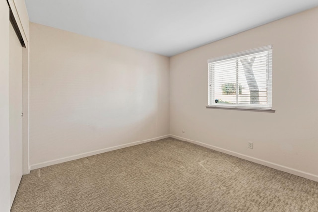 unfurnished bedroom featuring a closet, carpet floors, and baseboards