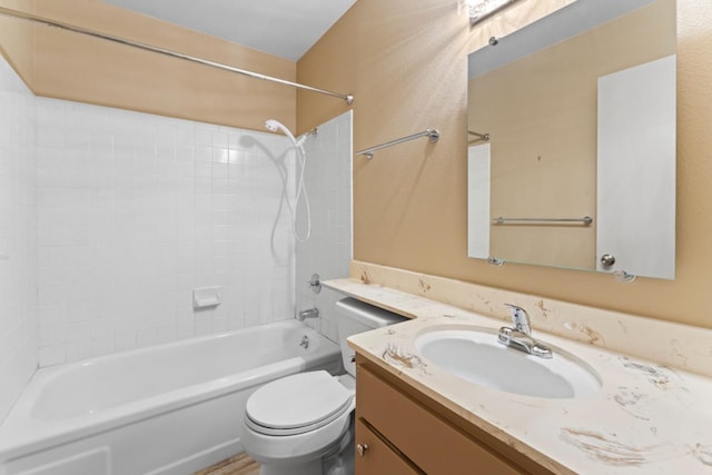 bathroom featuring washtub / shower combination, toilet, and vanity