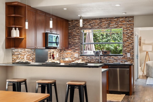 kitchen featuring open shelves, a peninsula, backsplash, and stainless steel appliances