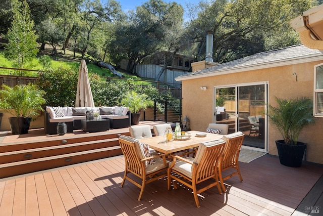 deck with outdoor lounge area, outdoor dining area, and fence