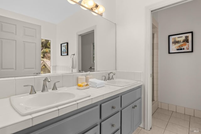 bathroom with tile patterned floors, double vanity, and a sink