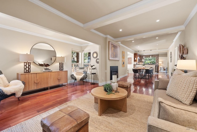 living area with ornamental molding, wood finished floors, recessed lighting, a fireplace, and baseboards