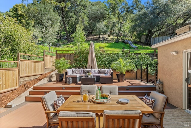 view of patio featuring a deck, an outdoor living space, outdoor dining area, and a fenced backyard