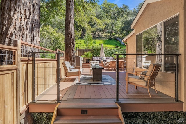 wooden terrace featuring an outdoor living space and fence