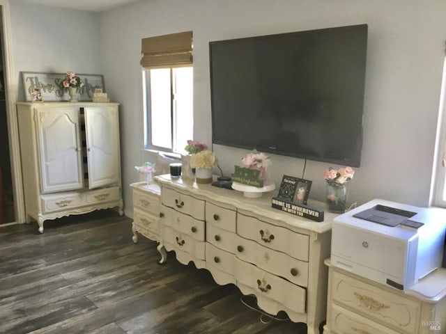 bedroom with dark wood-style flooring