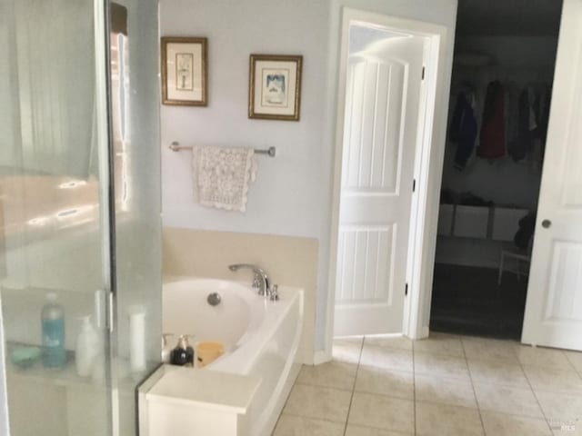 full bathroom with a garden tub, tile patterned flooring, and a shower stall