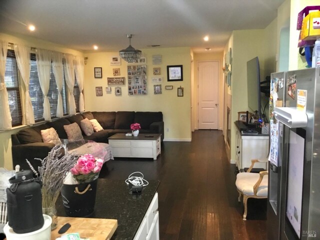 living room with dark wood-style floors and baseboards